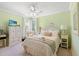 Cozy bedroom features soft green walls, a ceiling fan and a large white wardrobe at 6420 Longwood Dr., Murrells Inlet, SC 29576