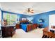 Comfortable bedroom featuring blue walls, wood furniture and a ceiling fan with lights at 6420 Longwood Dr., Murrells Inlet, SC 29576
