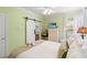 Bright bedroom features a sliding barn door to the bathroom, and light-green walls at 6420 Longwood Dr., Murrells Inlet, SC 29576