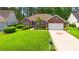 Charming brick home featuring a well-manicured lawn, lovely landscaping, and an attached two-car garage at 6420 Longwood Dr., Murrells Inlet, SC 29576