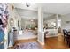 Open-concept living room with hardwood floors, carpeted seating area, and neutral paint at 6420 Longwood Dr., Murrells Inlet, SC 29576