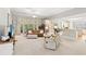 Spacious living room with large windows, neutral decor, and an open layout at 6420 Longwood Dr., Murrells Inlet, SC 29576