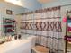 Cozy bathroom with a shower-tub combo and decorative shower curtain at 6805 Creekwatch Rd. # 105, Myrtle Beach, SC 29588