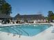 Outdoor swimming pool with lounge chairs and tables surrounded by a fence at 6805 Creekwatch Rd. # 105, Myrtle Beach, SC 29588