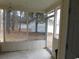 Screened-in porch offers views of the home's backyard and mature trees, inviting relaxation and outdoor enjoyment at 6805 Creekwatch Rd. # 105, Myrtle Beach, SC 29588