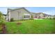 Spacious backyard with lush green grass, a fire pit, and a white picket fence at 720 Little Fawn Way, Myrtle Beach, SC 29579