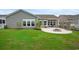 Lush green backyard featuring a circular patio with a fire pit and backyard seating at 720 Little Fawn Way, Myrtle Beach, SC 29579