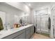 Modern bathroom featuring double sinks, a large mirror, and a glass-enclosed shower for a luxurious experience at 720 Little Fawn Way, Myrtle Beach, SC 29579