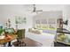 Cozy bedroom featuring plush carpeting, a ceiling fan, and large windows for natural lighting and views of the outside at 720 Little Fawn Way, Myrtle Beach, SC 29579