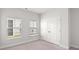 Bright bedroom featuring two windows, plush carpeting, and a double-door closet at 720 Little Fawn Way, Myrtle Beach, SC 29579