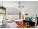 Bright bedroom with large windows, a ceiling fan, wood floors, and carpet, ideal for relaxation and comfort at 720 Little Fawn Way, Myrtle Beach, SC 29579