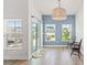 Bright dining area features wood floors, a modern light fixture, and sliding glass doors to outdoor living at 720 Little Fawn Way, Myrtle Beach, SC 29579