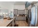 Modern kitchen with granite counters, stainless steel appliances, and gray cabinetry for a sophisticated look at 720 Little Fawn Way, Myrtle Beach, SC 29579