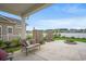 Covered patio area with comfortable seating and a fire pit in a well-maintained backyard at 720 Little Fawn Way, Myrtle Beach, SC 29579