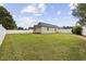 View of the large grassy backyard with white fence and verdant trees at 721 Dunlon Ct., Myrtle Beach, SC 29588