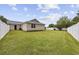 Spacious grassy backyard with verdant trees and white fence bordering the property at 721 Dunlon Ct., Myrtle Beach, SC 29588
