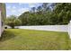 Expansive grassy backyard surrounded by verdant trees and a white fence at 721 Dunlon Ct., Myrtle Beach, SC 29588