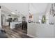 Open concept kitchen with stainless appliances flows seamlessly into dining area with wooden table and decorative lighting at 721 Dunlon Ct., Myrtle Beach, SC 29588