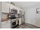 Well-equipped kitchen with stainless steel appliances, white cabinets, and a stylish tile backsplash at 721 Dunlon Ct., Myrtle Beach, SC 29588