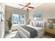 Bright bedroom featuring a ceiling fan, large windows, neutral walls, and beautifully coordinated furnishings at 750 Shine Ave. # 750, Myrtle Beach, SC 29577