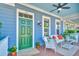 Inviting front porch with comfortable seating, a ceiling fan, and a charming blue exterior at 750 Shine Ave. # 750, Myrtle Beach, SC 29577