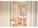Small half bathroom with pedestal sink, toilet, and tiled floors at 750 Shine Ave. # 750, Myrtle Beach, SC 29577