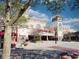 View of Grand 14 Cinema and other stores with manicured landscaping and tree providing shade at 750 Shine Ave. # 750, Myrtle Beach, SC 29577