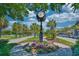 Street clock surrounded by a vibrant array of flowers and lush greenery at 750 Shine Ave. # 750, Myrtle Beach, SC 29577