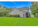 The backyard features well-kept lawn, landscaping, and views of the house which offers a delightful outdoor space at 751 Painted Bunting Dr. # E, Murrells Inlet, SC 29576