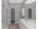 A well-lit bathroom has a double sink vanity, closet, and shower with glass doors at 751 Painted Bunting Dr. # E, Murrells Inlet, SC 29576