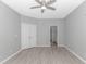 A spacious bedroom features a ceiling fan, closet, and door to the ensuite bathroom at 751 Painted Bunting Dr. # E, Murrells Inlet, SC 29576