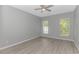 Clean bedroom with wood-style flooring and two windows at 751 Painted Bunting Dr. # E, Murrells Inlet, SC 29576