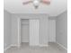 Bedroom featuring light gray walls, carpet, and a closet with bi-fold doors, providing ample storage space at 751 Painted Bunting Dr. # E, Murrells Inlet, SC 29576