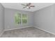 A bright bedroom with a ceiling fan and a window at 751 Painted Bunting Dr. # E, Murrells Inlet, SC 29576