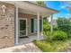 Inviting covered porch entrance with brick accents and manicured landscaping at 751 Painted Bunting Dr. # E, Murrells Inlet, SC 29576