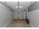 Empty garage with concrete floor, light gray walls, an overhead light fixture, and storage shelves in the corner at 751 Painted Bunting Dr. # E, Murrells Inlet, SC 29576