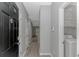 Hallway view featuring updated flooring, gray paint and a nearby laundry area at 751 Painted Bunting Dr. # E, Murrells Inlet, SC 29576
