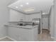 Well-lit kitchen featuring stainless steel refrigerator, white cabinets, and a breakfast bar at 751 Painted Bunting Dr. # E, Murrells Inlet, SC 29576