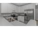 A modern kitchen featuring stainless steel appliances and light gray countertop at 751 Painted Bunting Dr. # E, Murrells Inlet, SC 29576
