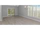 Open living room featuring light gray walls, wood floors, and bright natural light from window at 751 Painted Bunting Dr. # E, Murrells Inlet, SC 29576