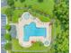 Aerial view of community pool with ample lounge chairs and a hot tub, surrounded by lush landscaping at 751 Painted Bunting Dr. # E, Murrells Inlet, SC 29576
