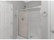 A bright shower with a sliding glass door and white tile surround at 751 Painted Bunting Dr. # E, Murrells Inlet, SC 29576