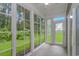 Cozy sunroom with large windows that let in plenty of natural light, offering beautiful views of the outdoors at 751 Painted Bunting Dr. # E, Murrells Inlet, SC 29576