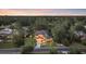 Aerial view of a luxurious home with manicured landscaping, mature trees, and a circular driveway at sunset at 81 Cascade Dr., Murrells Inlet, SC 29576