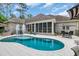 Backyard with a sparkling pool featuring a fountain and a screened-in porch with comfortable seating at 81 Cascade Dr., Murrells Inlet, SC 29576