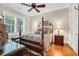 Traditional bedroom with four-poster bed, hardwood floors, side tables, and large window with shutters at 81 Cascade Dr., Murrells Inlet, SC 29576