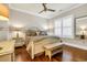 Bedroom with a white wood frame bed, hardwood flooring, neutral walls, and a bench by the window at 81 Cascade Dr., Murrells Inlet, SC 29576