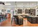 Open kitchen and dining area with black cabinets, hardwood flooring, and views of the breakfast area at 81 Cascade Dr., Murrells Inlet, SC 29576
