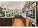 Modern kitchen featuring dark cabinetry, stainless steel appliances, and ample counter space for cooking at 81 Cascade Dr., Murrells Inlet, SC 29576