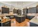 Gourmet kitchen featuring dark cabinets, stone backsplash, hardwood floors and a center island at 81 Cascade Dr., Murrells Inlet, SC 29576